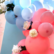 pink and blue balloons on backdrops with white roses