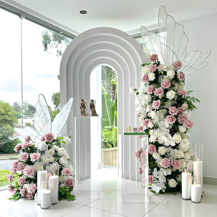 white 3d arch backdrop with pink and white flowers and white led butterflies