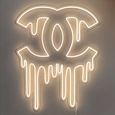 warm white dripping chanel neon sign hanging on wall