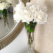 bunch of white reach touch roses placed in glass vase against mirror