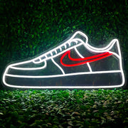 red air force 1 nike sneaker neon sign with green grass background