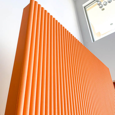 close up image of orange slatted rectangle backdrop board
