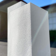 white limestone plinth with blue sky in background