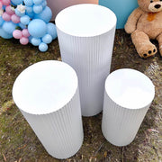 top of 3 white ripple plinths on grass at gender reveal party