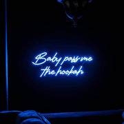 blue baby pass me the hookah neon sign above couch in shisha bar