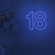 blue 18 neon sign hanging on wall with balloons