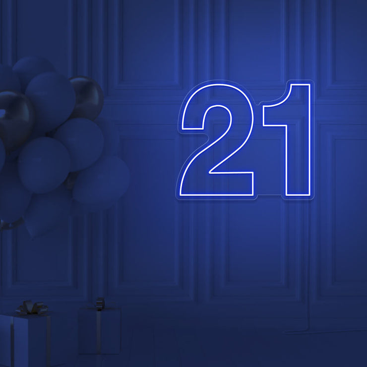 blue  21 neon sign hanging on wall with balloons