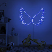 blue angel wings neon sign hanging  on kids bedroom wall