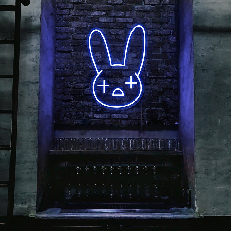 blue bad bunny neon sign hanging on bar wall