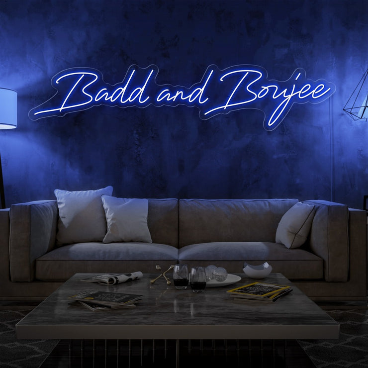 blue bad and boujee neon sign hanging on living  room wall