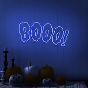 blue boo neon sign with halloween pumpkins on floor