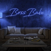 blue boss babe neon sign hanging on living room wall