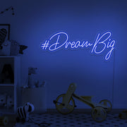 blue dream big neon sign hanging on kids bedroom wall