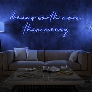 blue dreams worth more than money neon sign hanging on living room wall
