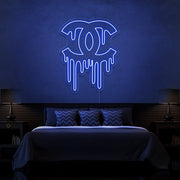 blue dripping chanel neon sign hanging on bedroom wall