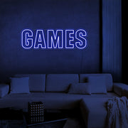 blue games neon sign hanging on games room wall