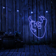 blue  ghost neon sign hanging on timber wall