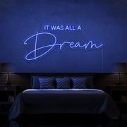 blue it was all a dream neon sign hanging on bedroom wall