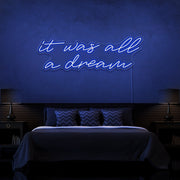 blue it was all a dream neon sign hanging on bedroom wall
