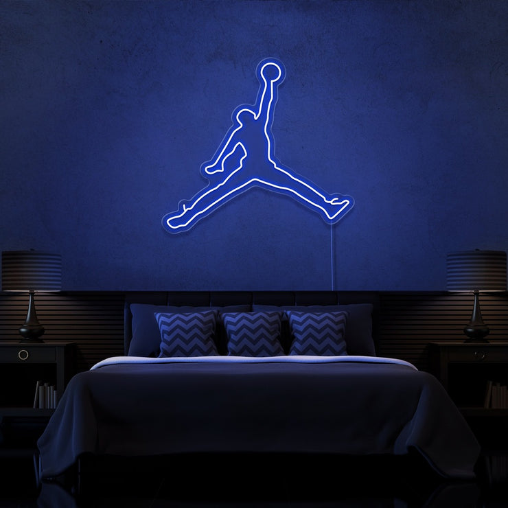 blue jordan jumpman neon sign hanging on bedroom wall