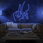 blue LA fingers neon sign hanging on living room wall