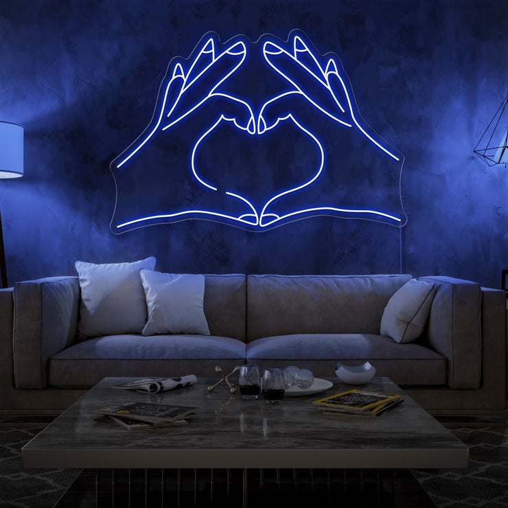 blue love hands neon sign hanging on living room wall