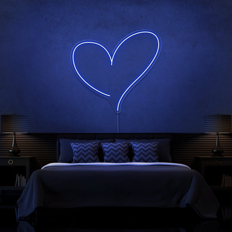 blue love heart neon sign hanging on bedroom wall