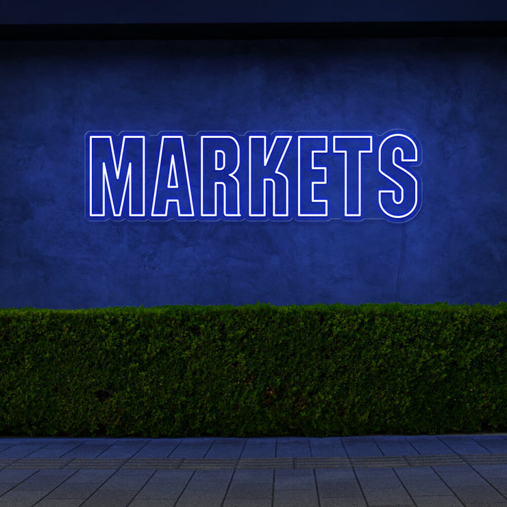 blue markets neon sign hanging on outside wall