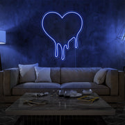 blue melting heart neon sign hanging on living room wall