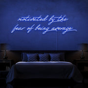 blue motivated by the fear of being average neon sign hanging on bedroom wall