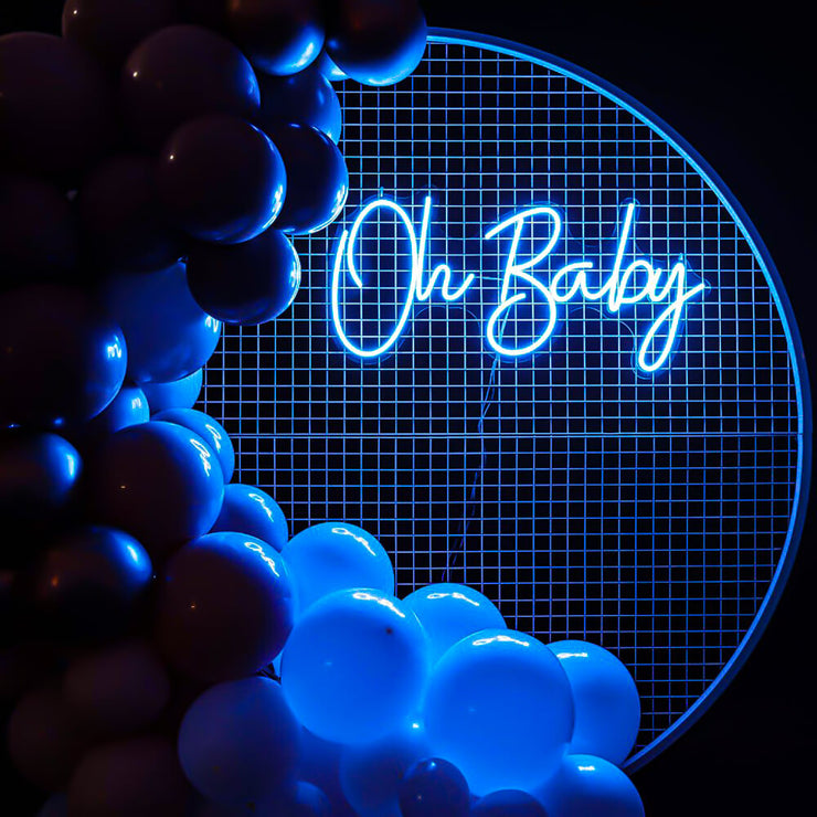 blue oh baby neon sign hanging on white mesh backdrop frame with balloons
