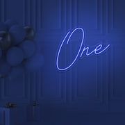 blue 1st birthday neon sign hanging on wall with balloons