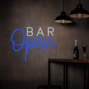 blue open bar neon sign hanging on bar wall