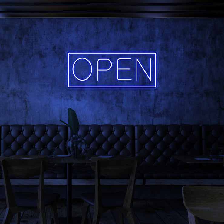 blue open neon sign hanging on cafe wall
