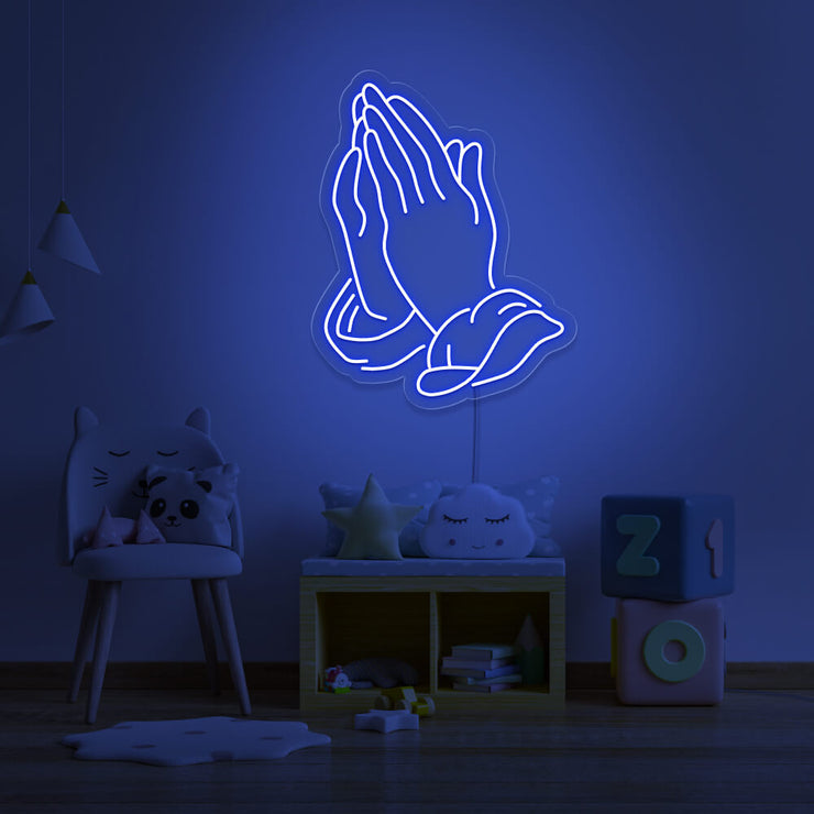 blue praying hands neon sign hanging on kids bedroom wall