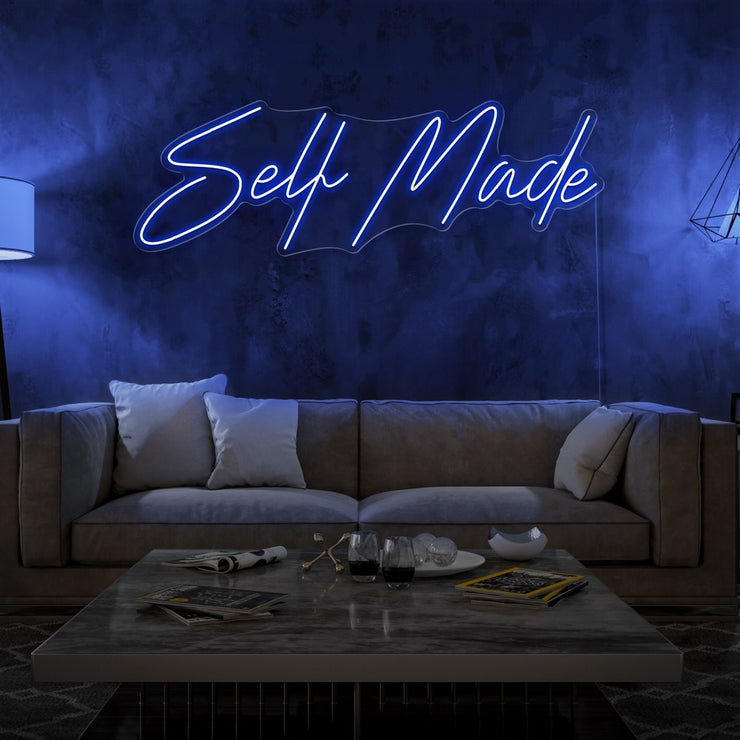 blue self made neon sign hanging on living room wall