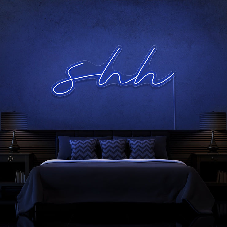 blue shh neon sign hanging on bedroom wall