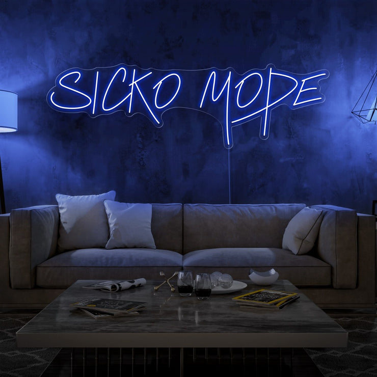 blue sicko mode neon sign hanging on living room wall