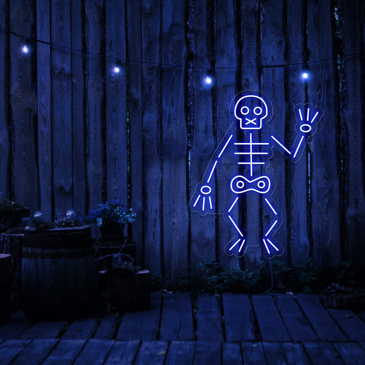blue skeleton neon sign hanging on timber fence