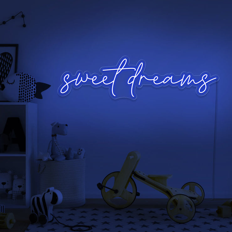 blue sweet dreams neon sign hanging on kids bedroom wall