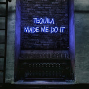 blue tequila made me do it neon sign hanging on bar wall