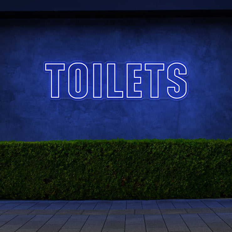 blue toilets neon sign hanging on outdoor wall