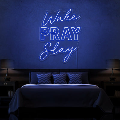 blue wake pray slay neon sign hanging on bedroom wall