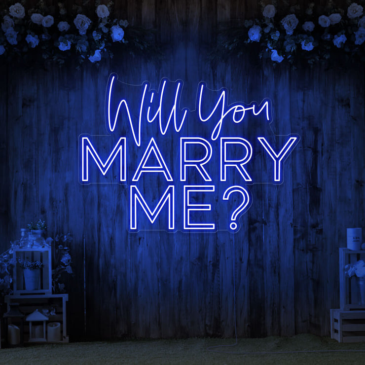 blue will you marry me neon sign hanging on timber wall