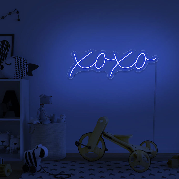 blue xoxo neon sign hanging on kids bedroom wall