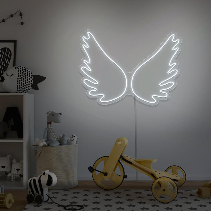 cold white angel wings neon sign hanging on kids bedroom wall