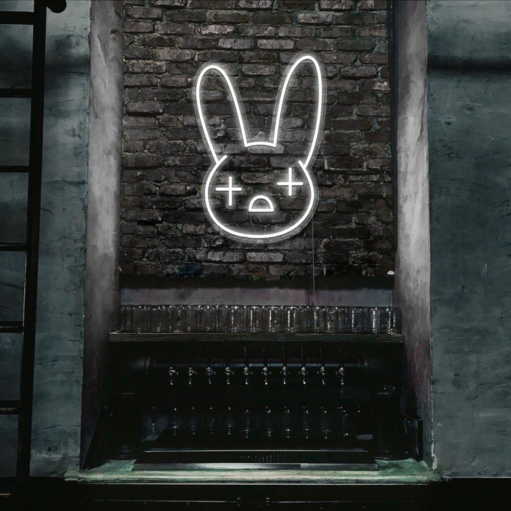 cold white bad bunny neon sign hanging on bar wall