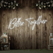 cold white better together neon sign hanging on timber wall