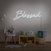 cold white blessed neon sign hanging on kids bedroom wall