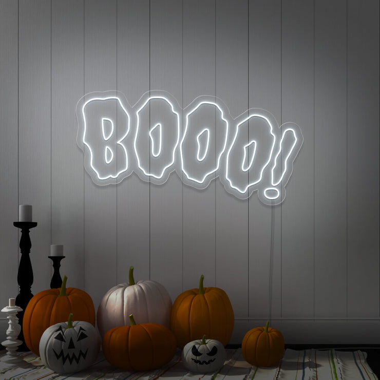 cold white boo neon sign with halloween pumpkins on floor